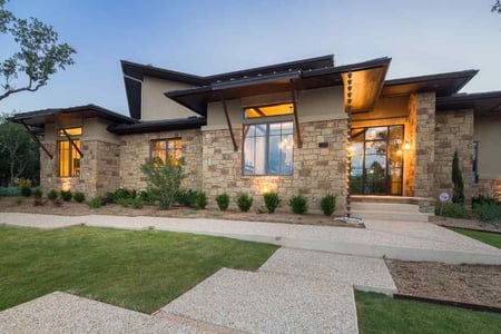 Elegant stone exterior of a custom home by J. Bryant Boyd in Central Texas Hill Country