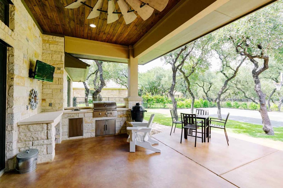 Outdoor kitchen and patio area in a custom home by J. Bryant Boyd in Central Texas Hill Country