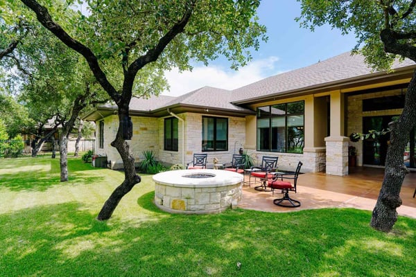 Backyard patio with seating area in a custom home by J Bryant Boyd, Georgetown, Texas