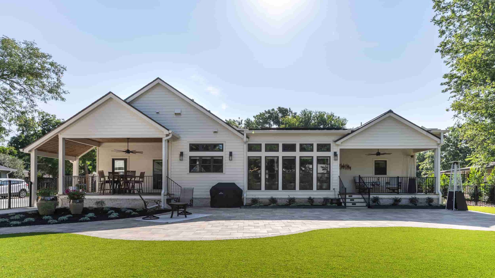 A beautiful home in Texas, showcasing a generous yard and a stylish patio, designed by J Bryant Boyd.  | J Bryant Boyd 