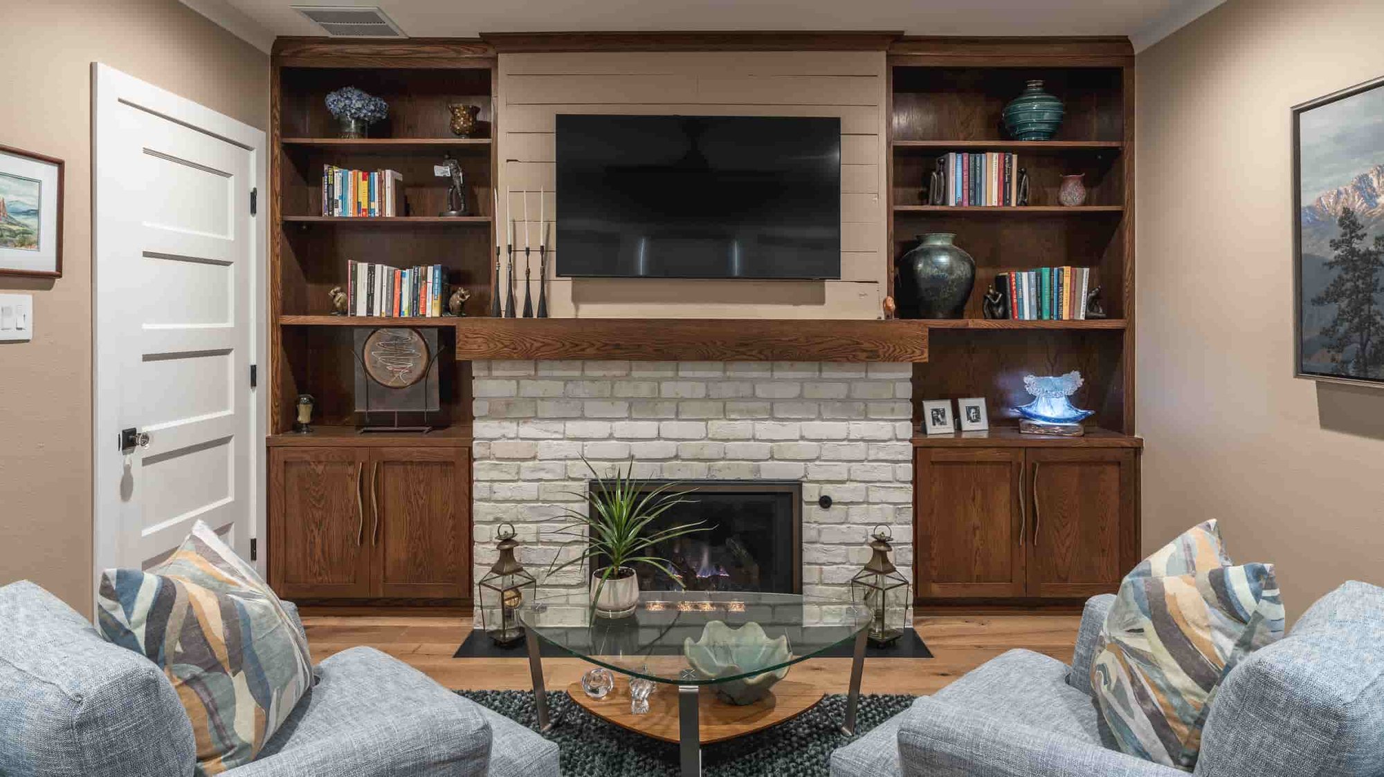  A cozy Texas living room featuring a fireplace and a television, designed by J Bryant Boyd, exuding warmth and comfort.  | J Bryant Boyd 