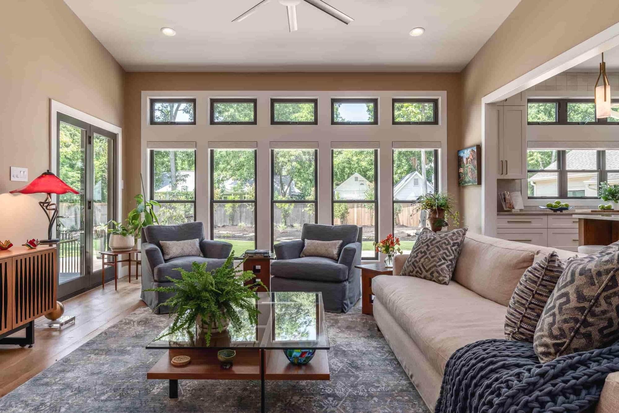  A Texas living room designed by J Bryant Boyd, highlighting a couch, coffee table, and a ceiling fan for comfort.  | J Bryant Boyd 