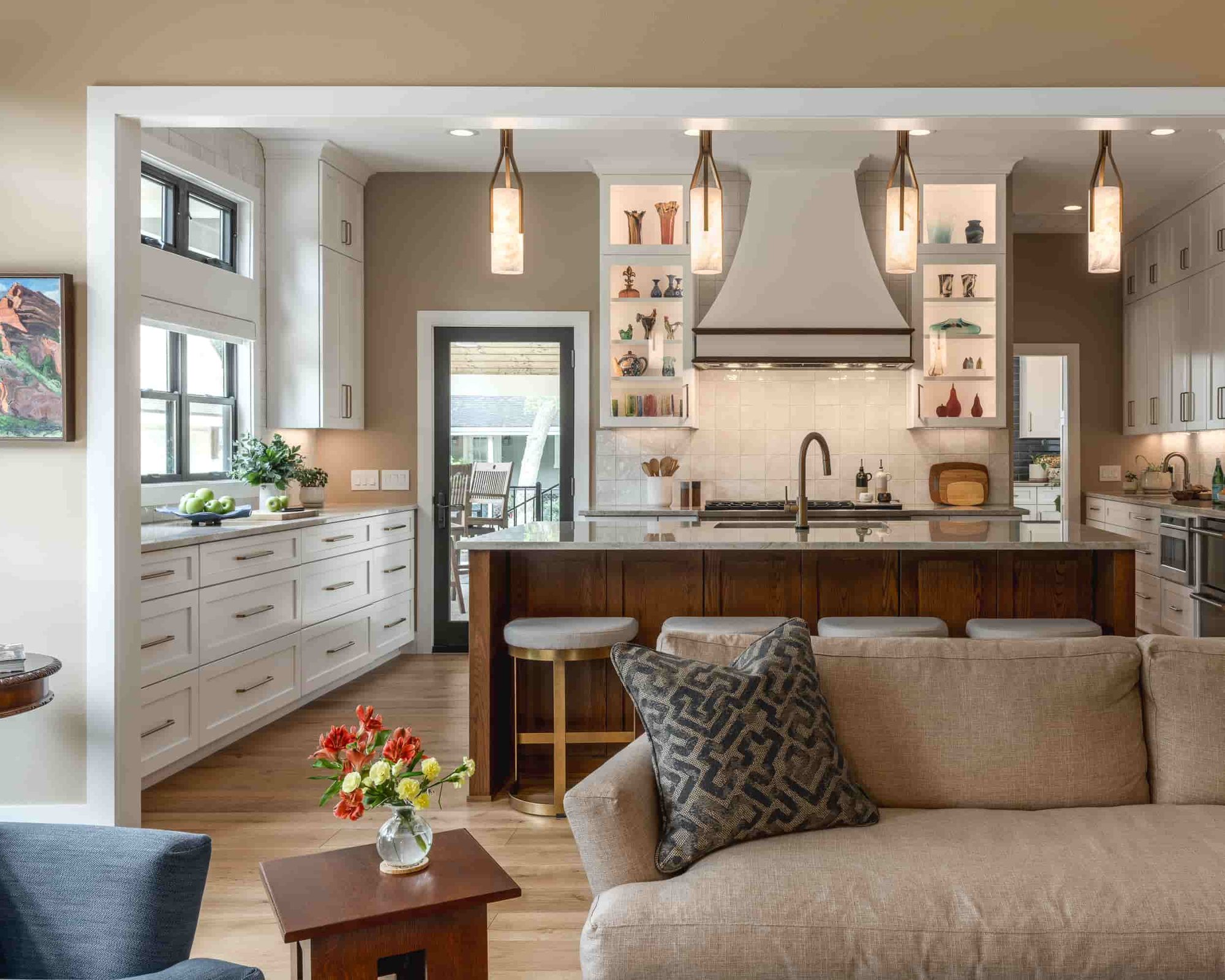 A Texas kitchen and living room designed by J Bryant Boyd, showcasing a welcoming couch and an elegant coffee table.  | J Bryant Boyd 