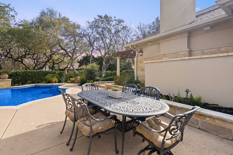 Custom home outdoor dining area near pool by J Bryant Boyd in Georgetown, TX-1