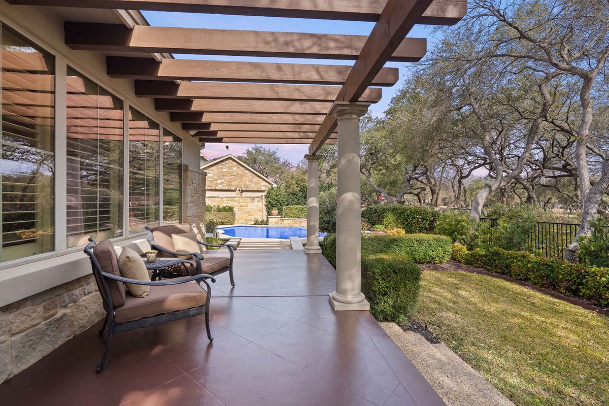 View of backyard pool and lounging area in a custom home by J Bryant Boyd, Georgetown TX