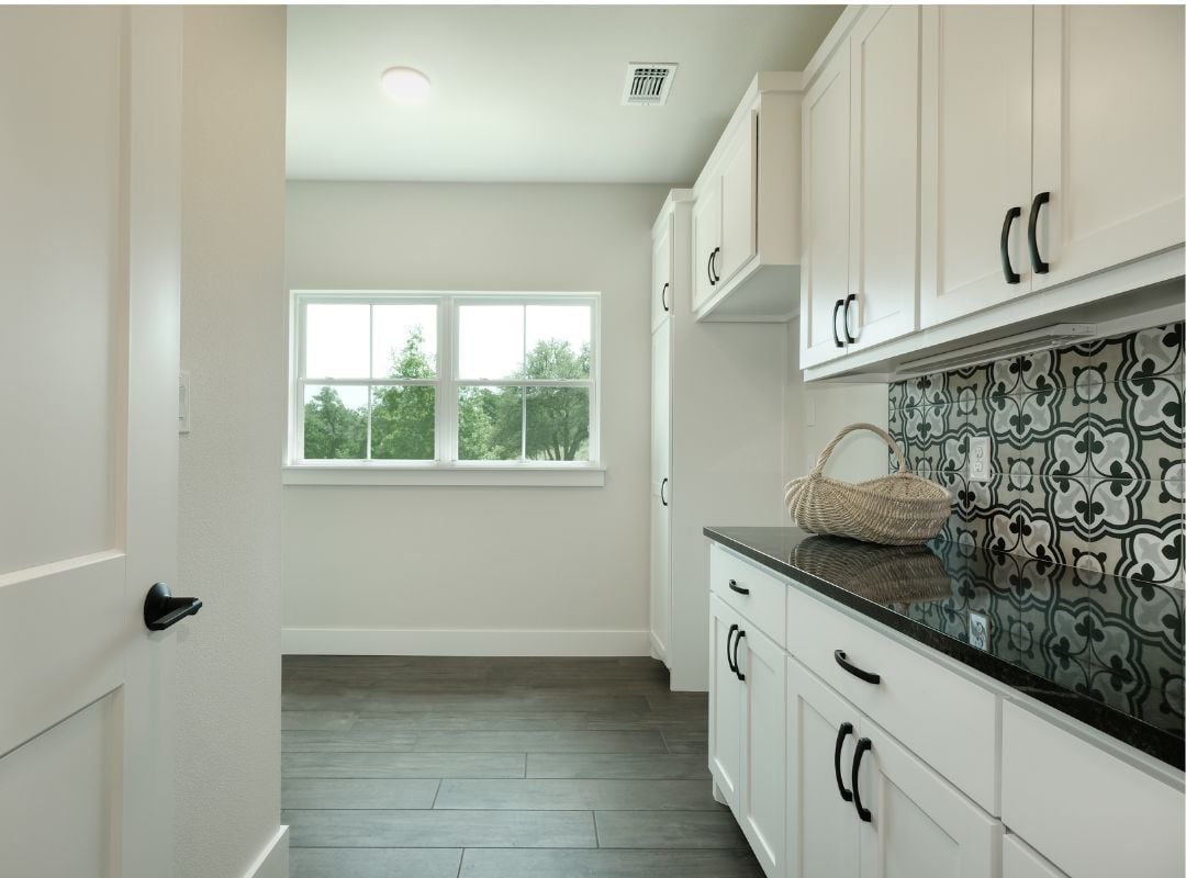 Laundry room with back counter tiling Texas | J Bryant Boyd