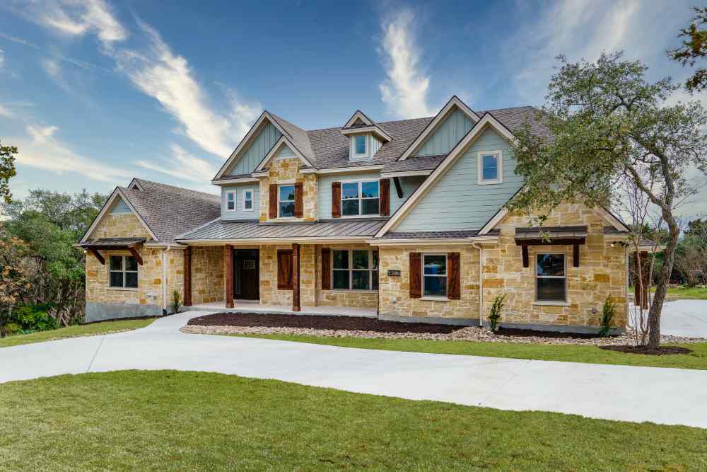 Beautiful two-story custom home with stone and wood exterior by J. Bryant Boyd in Central Texas