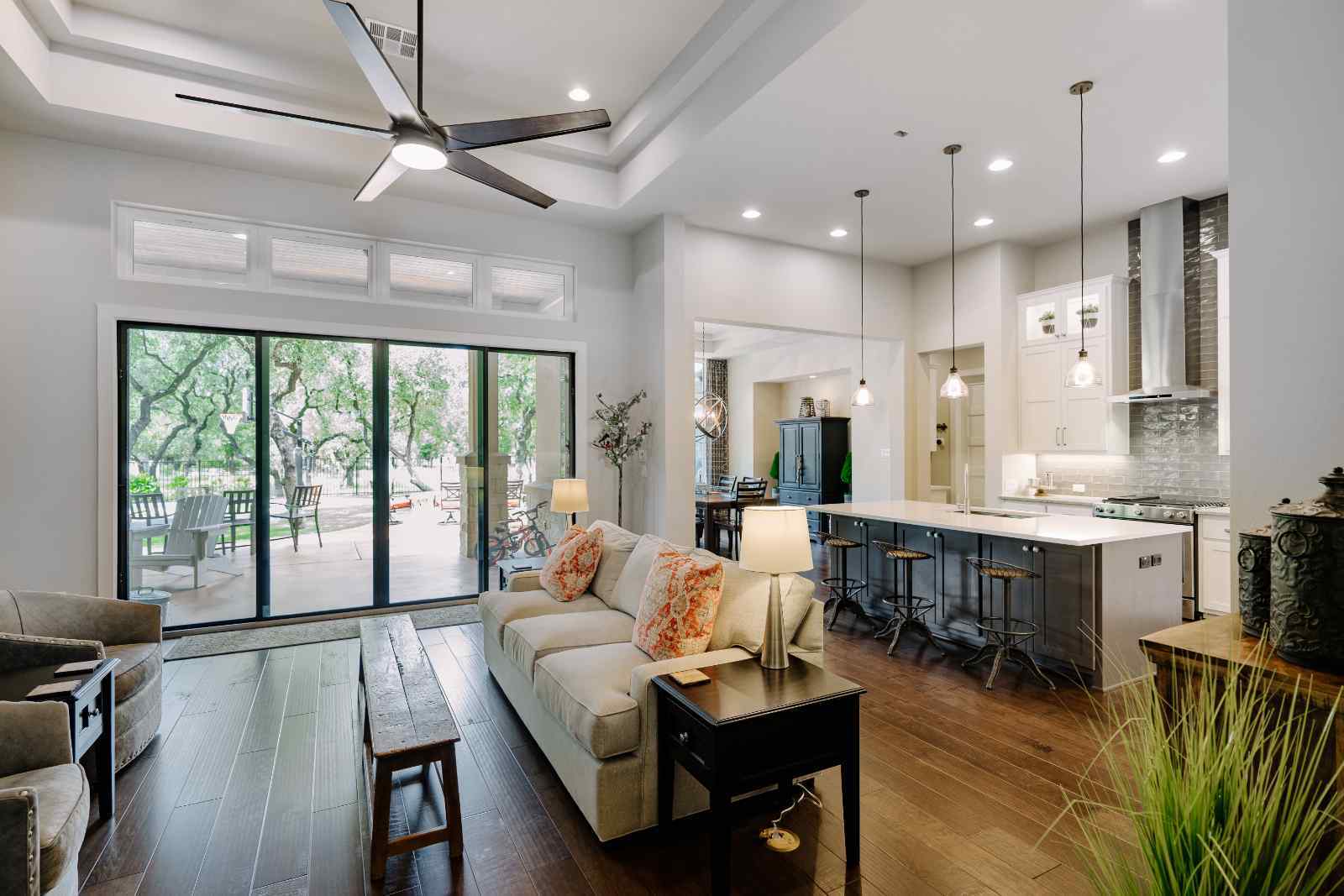 Open living and kitchen area with large windows and natural light, designed by J. Bryant Boyd in Central Texas Hill Country