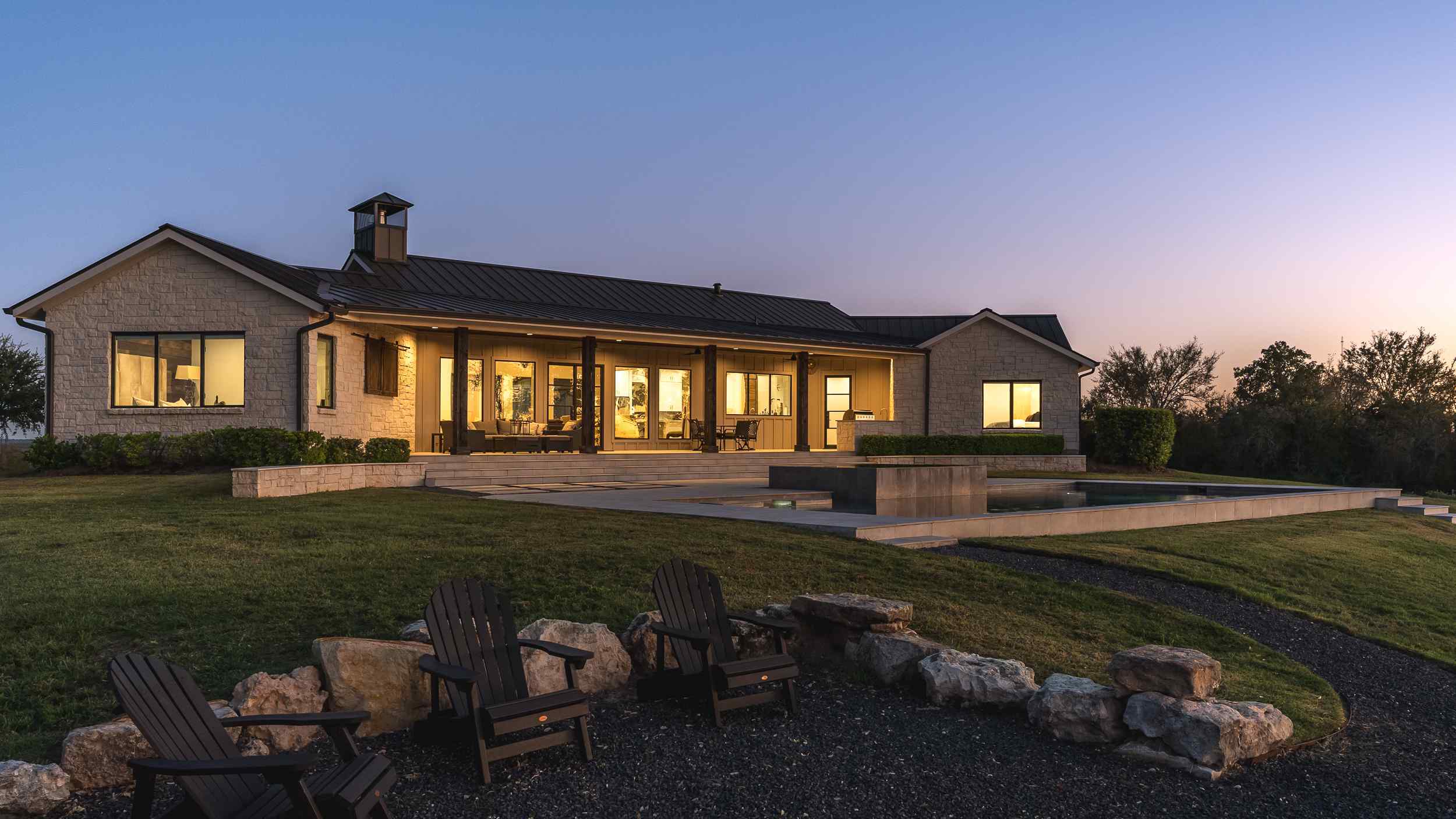 Central Texas Modern Farmhouse with Beautiful Sunset in Background by J. Bryant Boyd