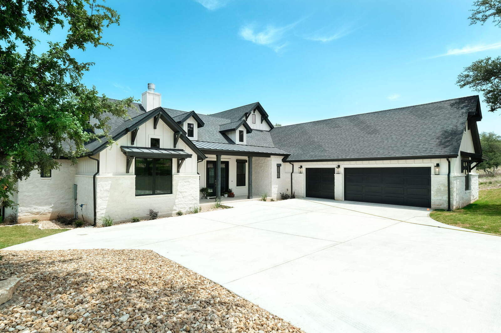 Custom home exterior by J Bryant Boyd in Georgetown, Texas featuring a large driveway