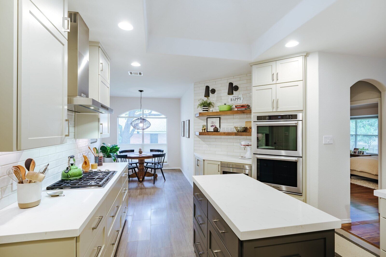 Full view of a modern kitchen remodel by J Bryant Boyd in Georgetown, Texas with an open layout and stylish dining area