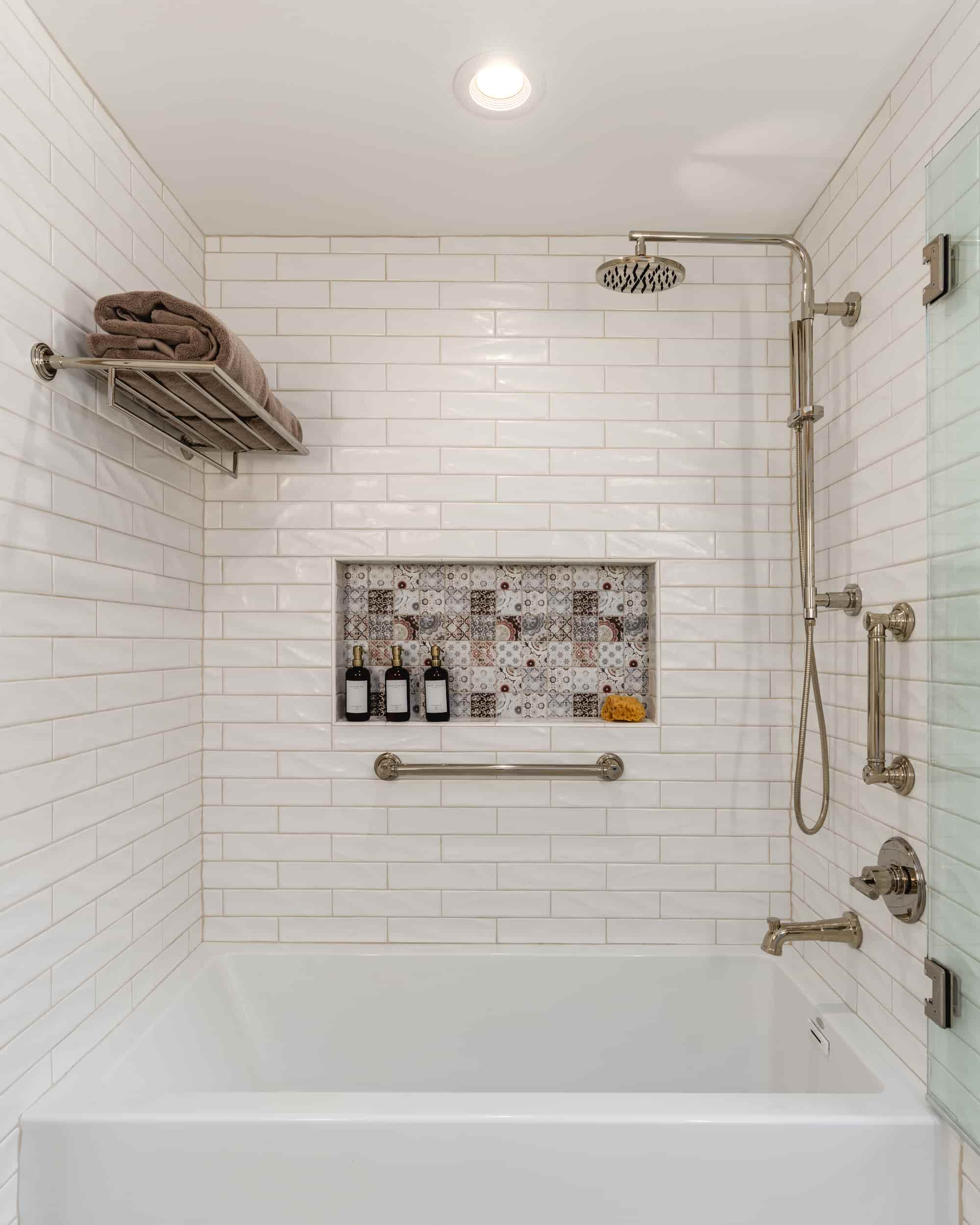 A pristine white bathroom featuring a tub and shower, designed by J Bryant Boyd, located in Texas.